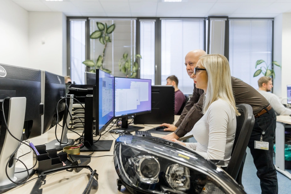 two Tiyo specialists work with programs for the A-Class Surfacing service