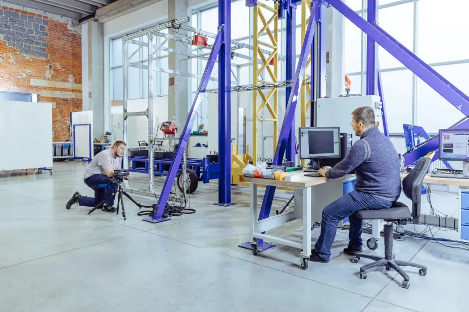 two specialists perform bumper tests using a pendulum