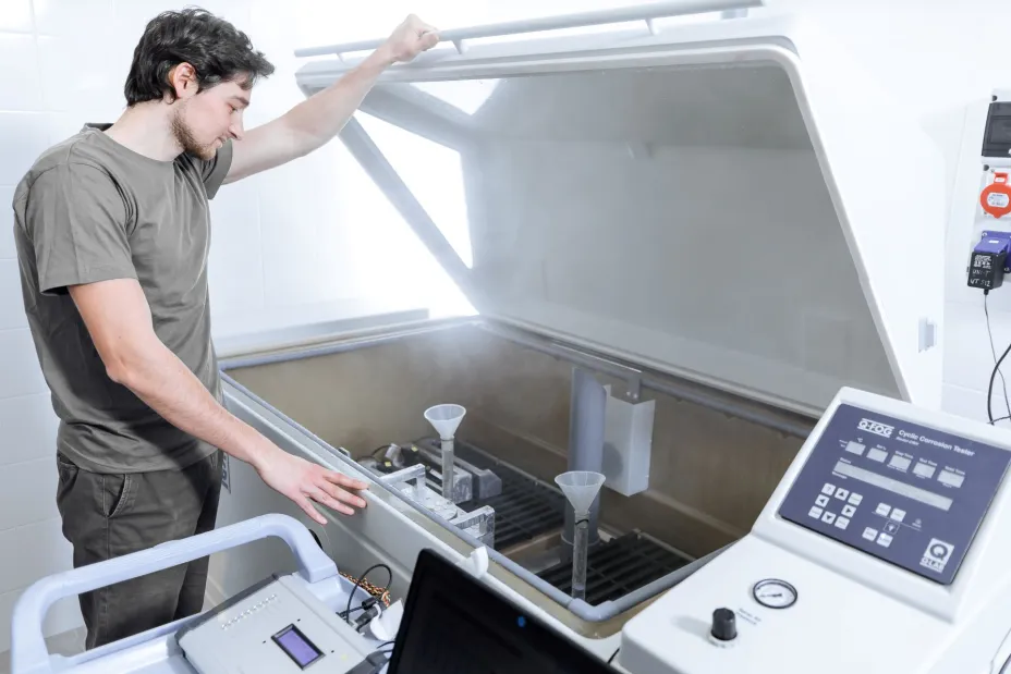 TIYO employee handling corrosion testing equipment