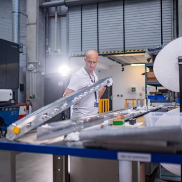 TIYO specialist holding an aerospace aluminium component TIYO specialist holding an aerospace aluminium component