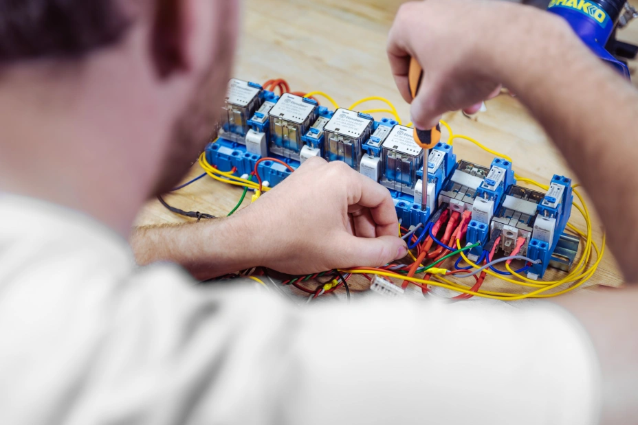 TIYO technician carefully connects the contacts of the test equipment